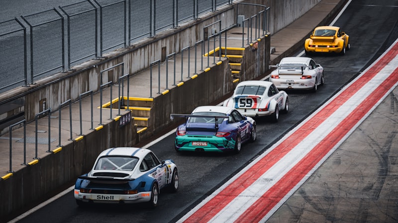 Race cars speeding down the racetrack.