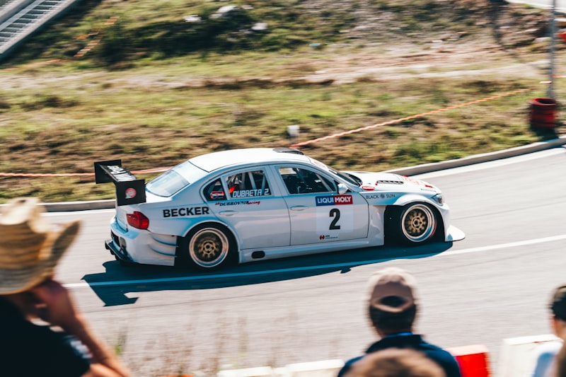 White race car with number 2 speeds down track