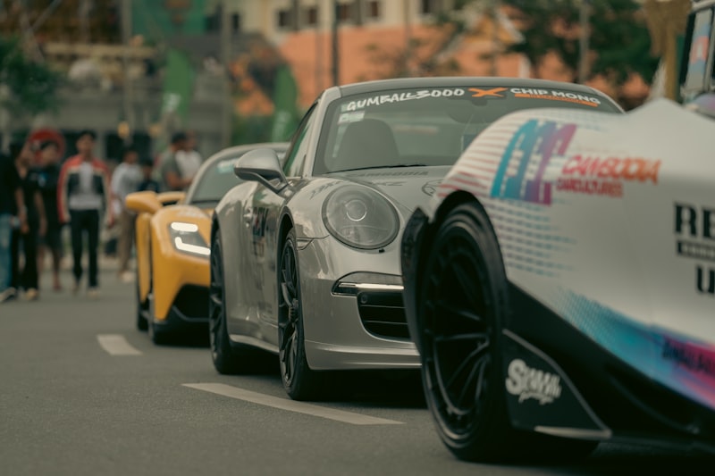Several sports cars are lined up on the street.