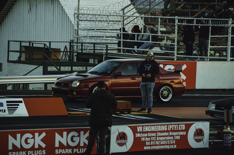 A red car prepares to race at the track.