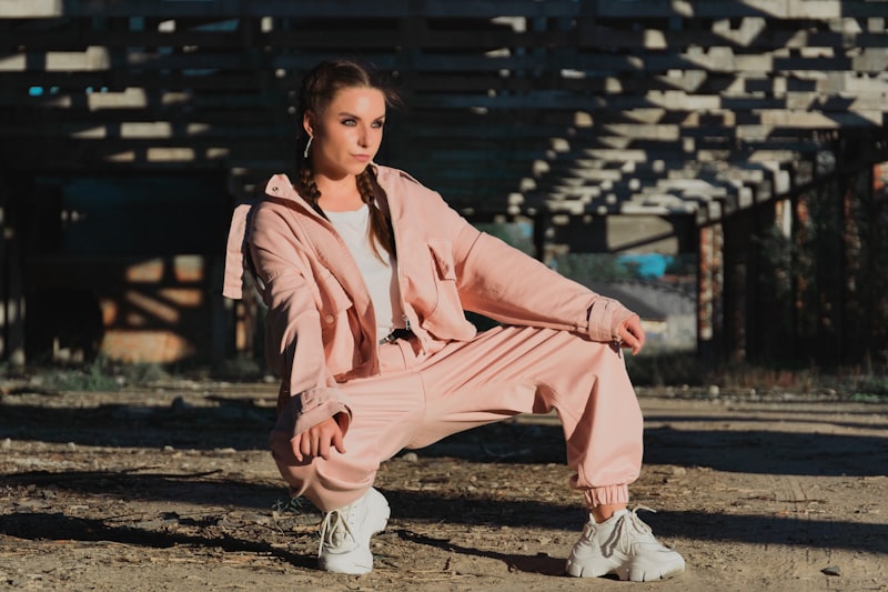 A woman in a pink sweat suit posing for a picture