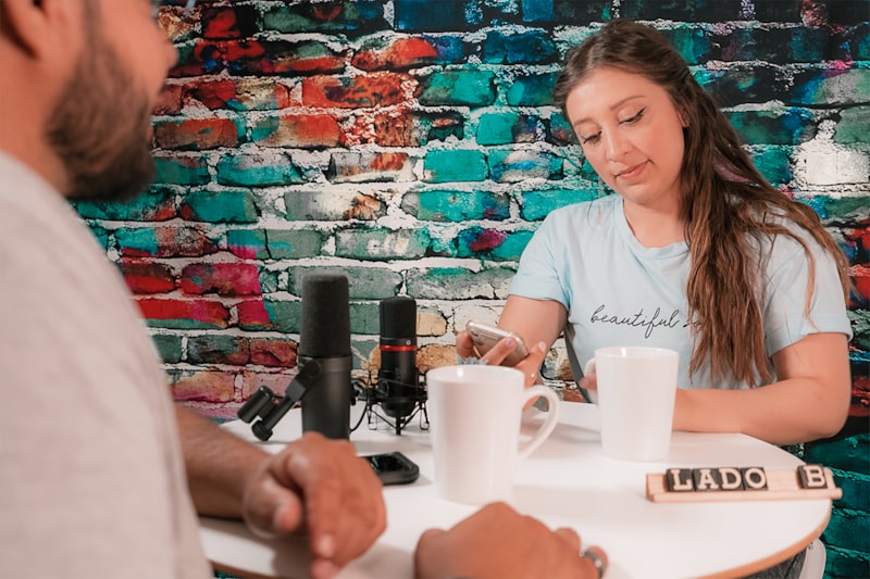 woman in white crew neck t-shirt holding white ceramic mug