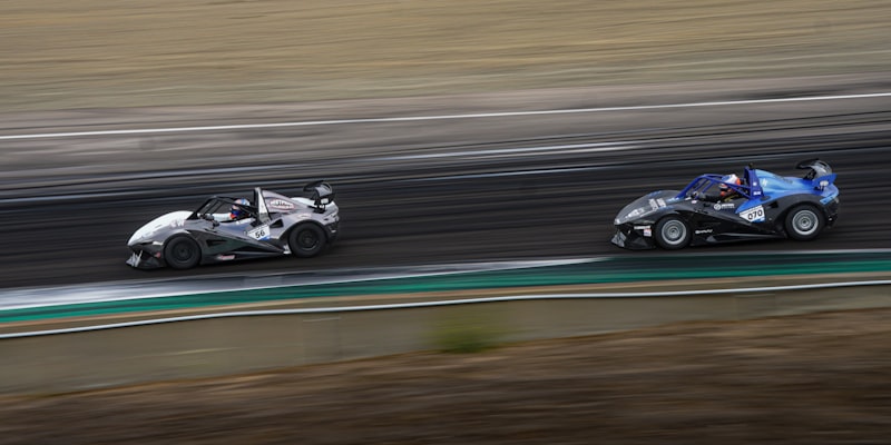 Two race cars speeding down a track.
