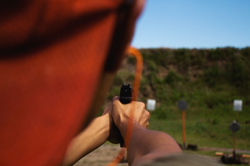 person holding black and orange device