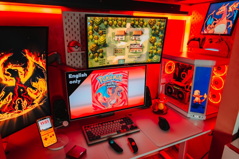 Gaming setup with multiple screens and red lighting.