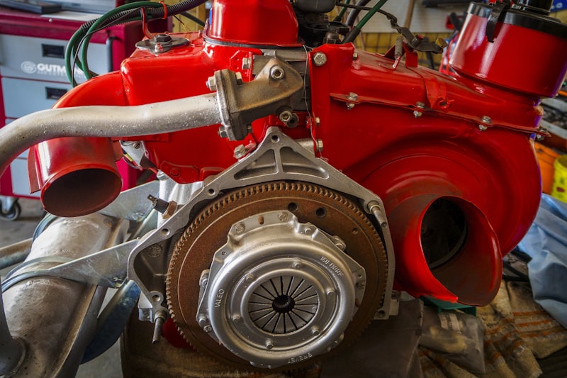 a close up of a red engine in a garage