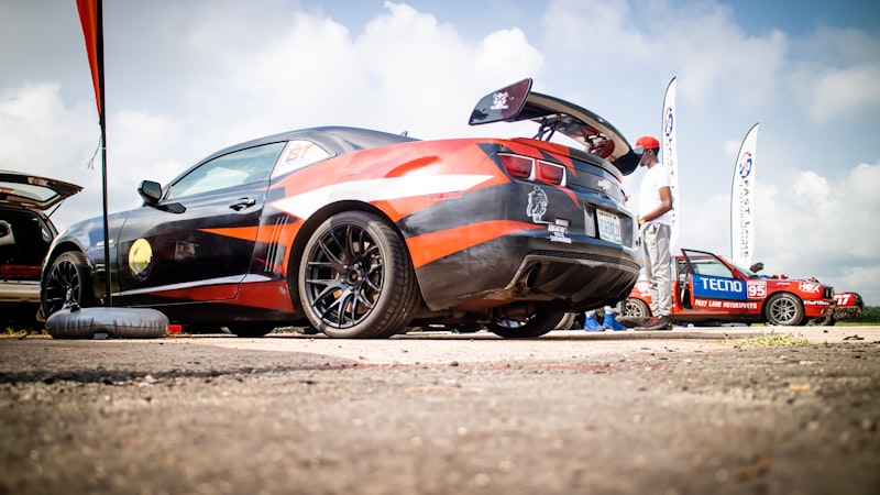 black and orange sports coupe on park during daytime