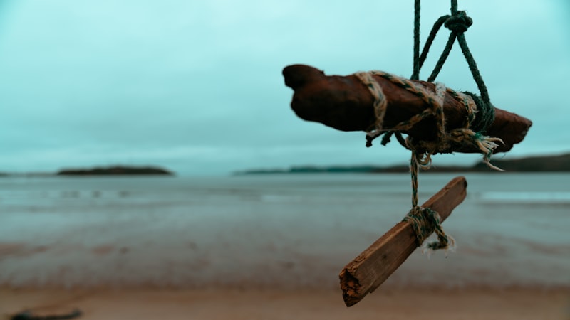 a piece of wood hanging from a rope