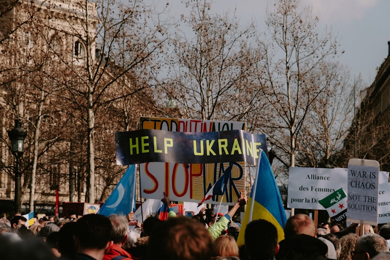 a large group of people holding signs and flags