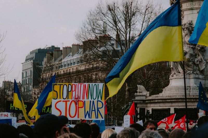 a crowd of people holding signs and flags