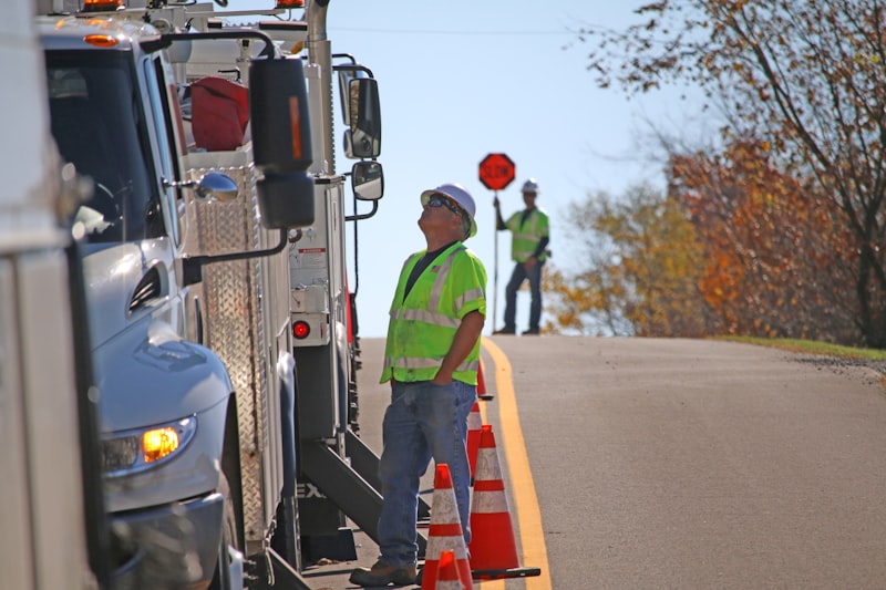 man standing beside parked truck