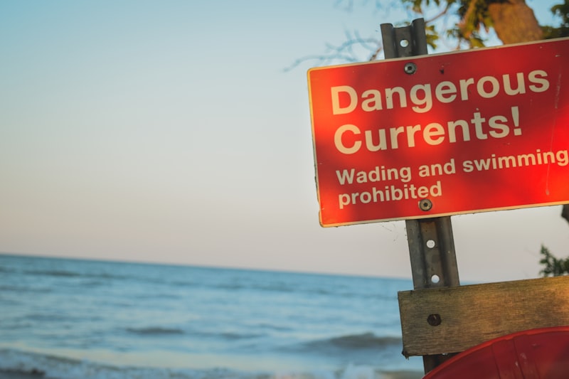 dangerous currents signage on wood