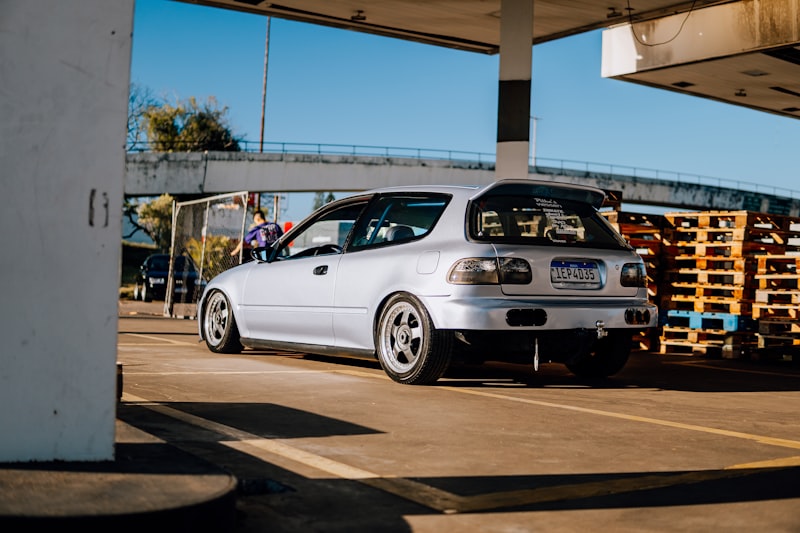 a small white car parked in a parking lot