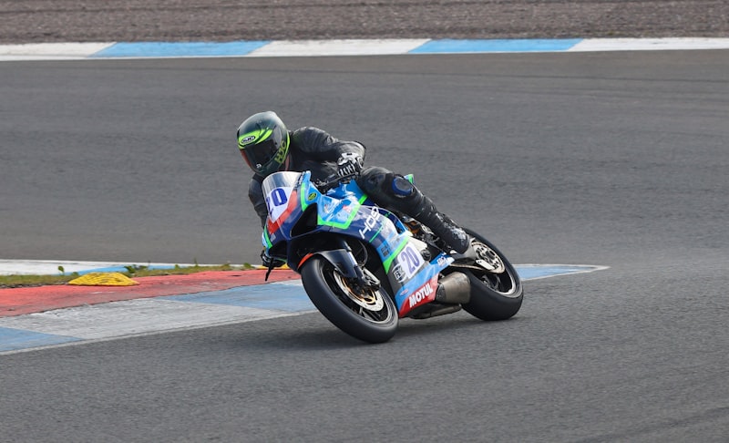 Motorcyclist leans into a turn on a race track