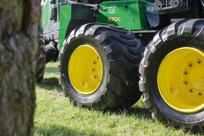 green tractor on green grass field during daytime