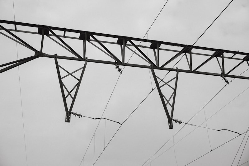 High-voltage power lines against a cloudy sky.