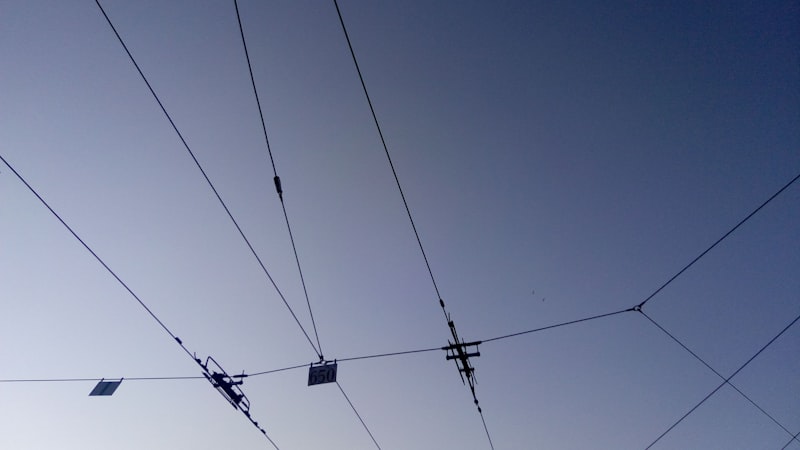 power lines and wires against a blue sky