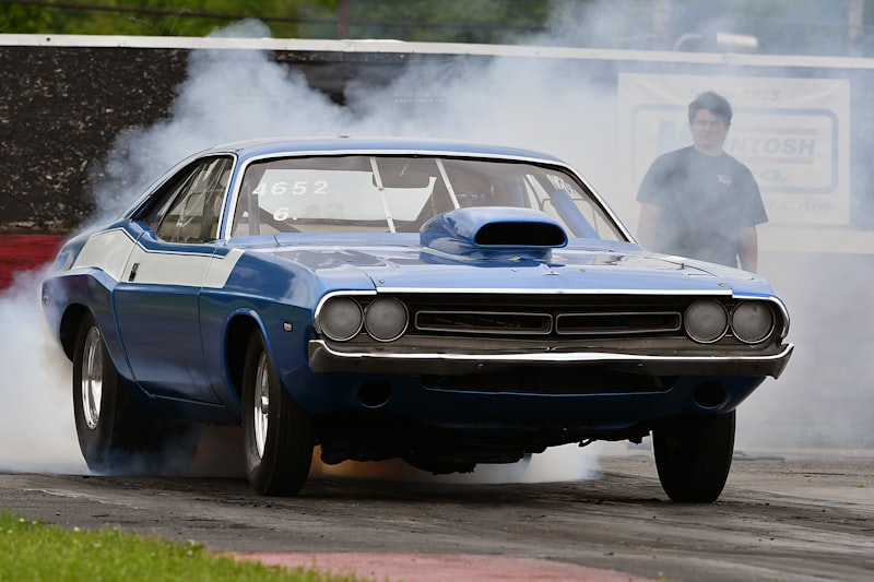 a blue car with smoke coming out of it