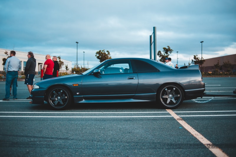 black coupe on gray asphalt road during daytime