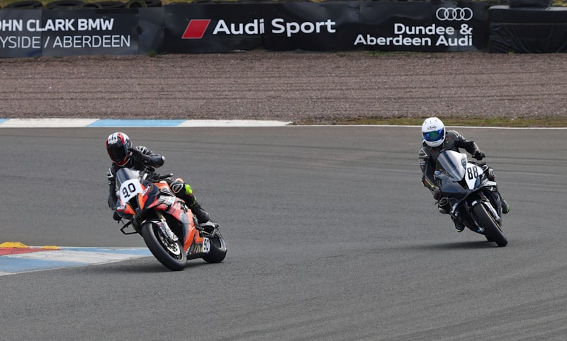 Two motorcyclists racing on a track