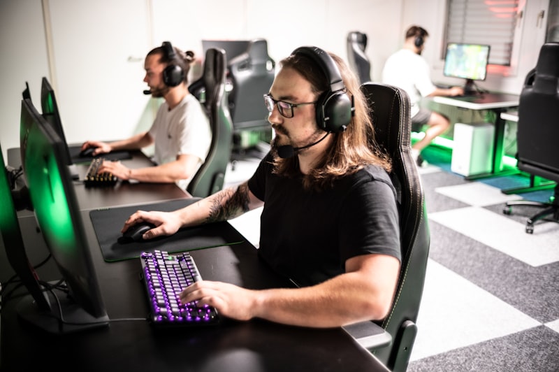 A man sitting in front of a computer with headphones on