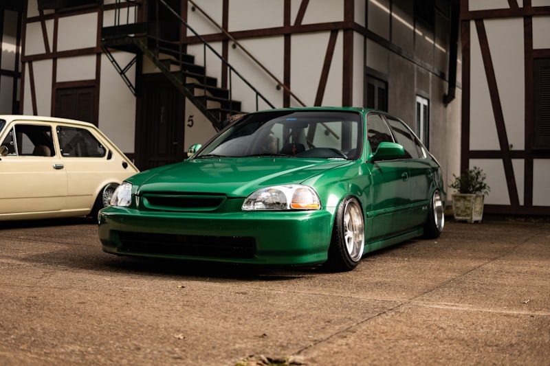 A shiny green car parked outdoors.