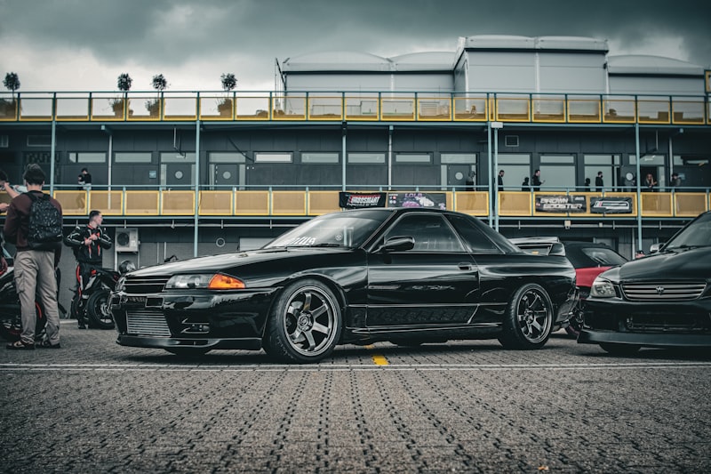 A black sports car parked outside a building