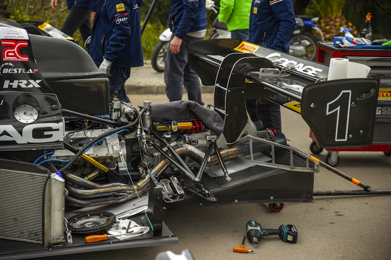 a race car with its engine broken down on the ground