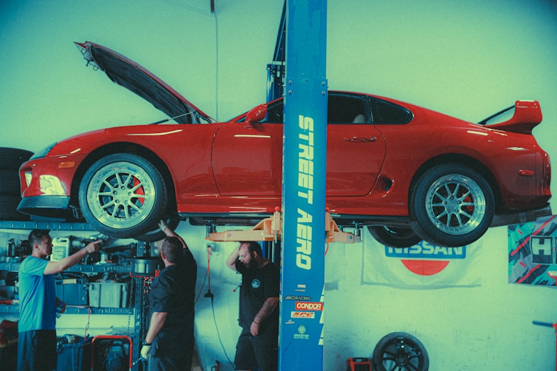 two men working on a car in a garage