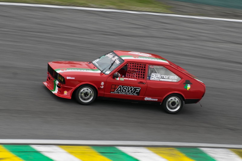 a red car driving down a race track