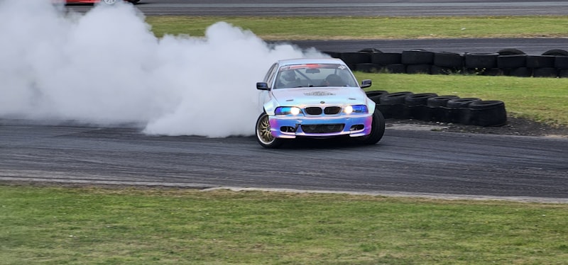 A blue car with smoke coming out of it