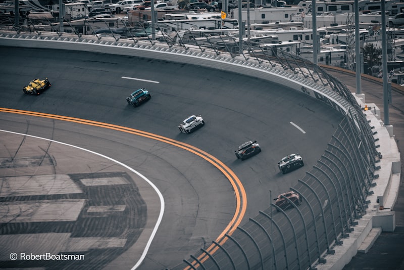 a group of cars driving down a race track