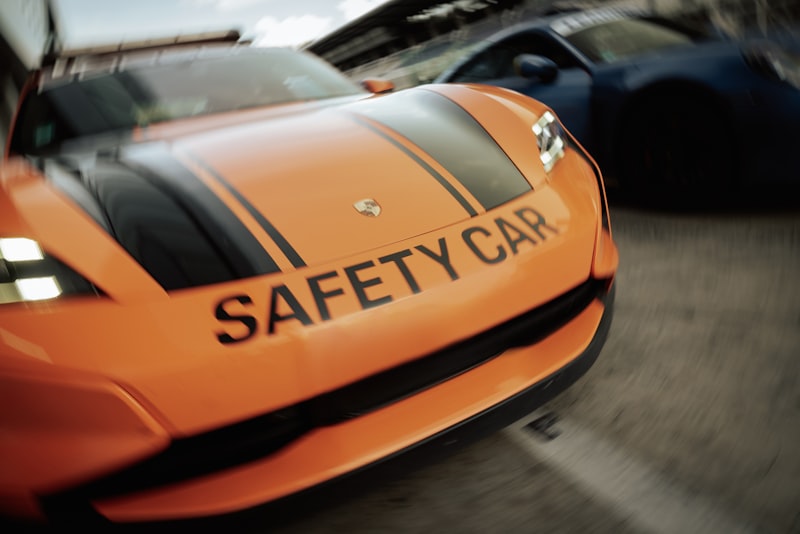 A safety car leads other cars on the track.