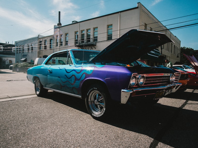 purple chevrolet camaro parked on street during daytime