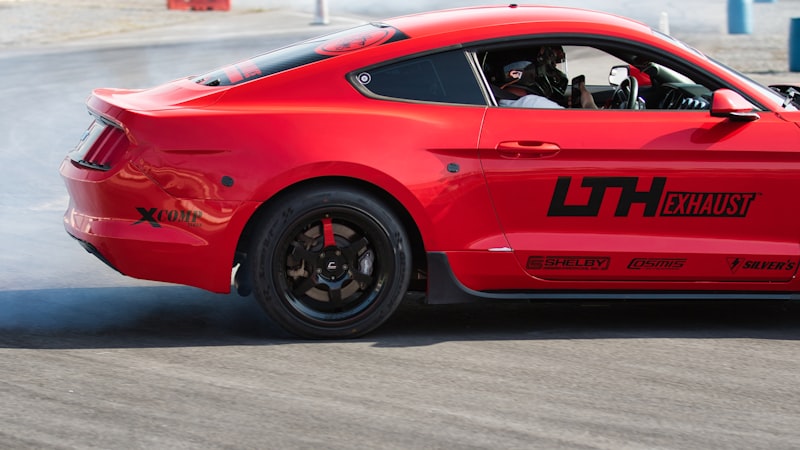 Red sports car drifting on a track
