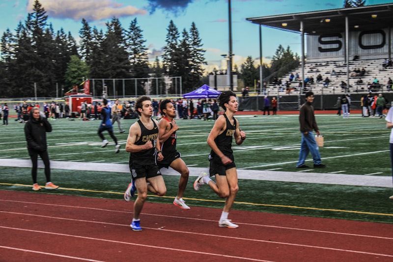 a group of men running on a track