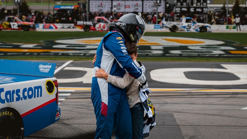 A racer embraces someone after a race.