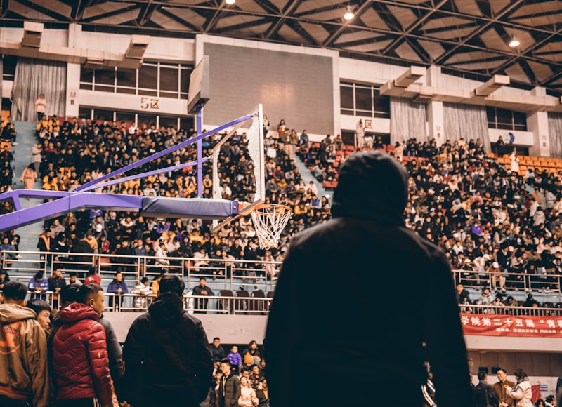 silhoutte of man watching basketball