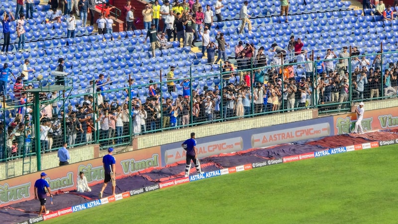 Spectators watch a baseball game from the stands.